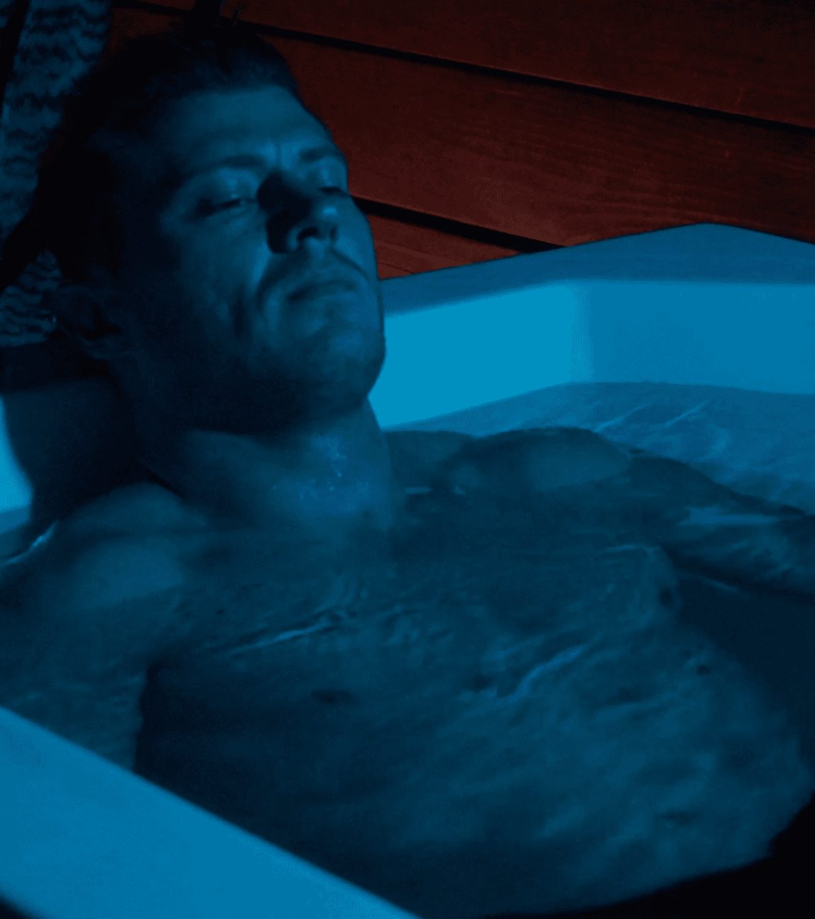 Man resting in a cold plunge